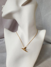 Load image into Gallery viewer, Hummingbird pendant worn on a chain, showing scale against the body