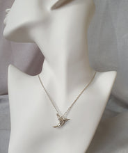 Load image into Gallery viewer, Close-up of the hummingbird pendant showing carved wing detail